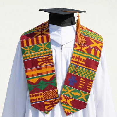 Graduation stole with vibrant Kente cloth pattern draped over a cap and gown, clean background
